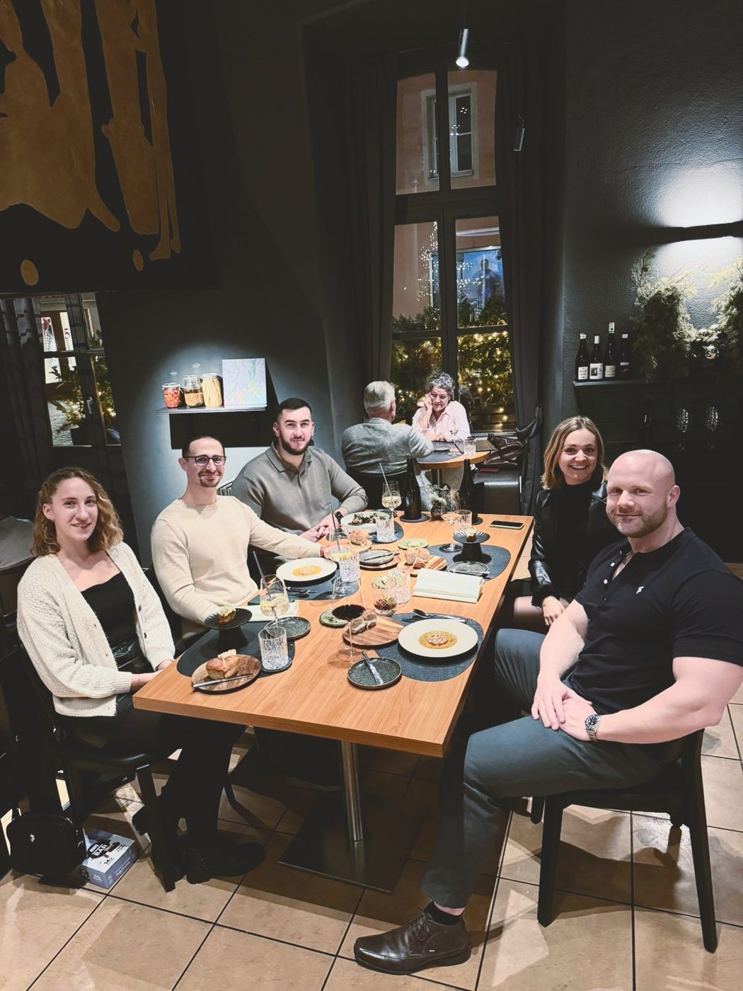 The Coaching Central team at dinner in a restaurant, team meetup 2023